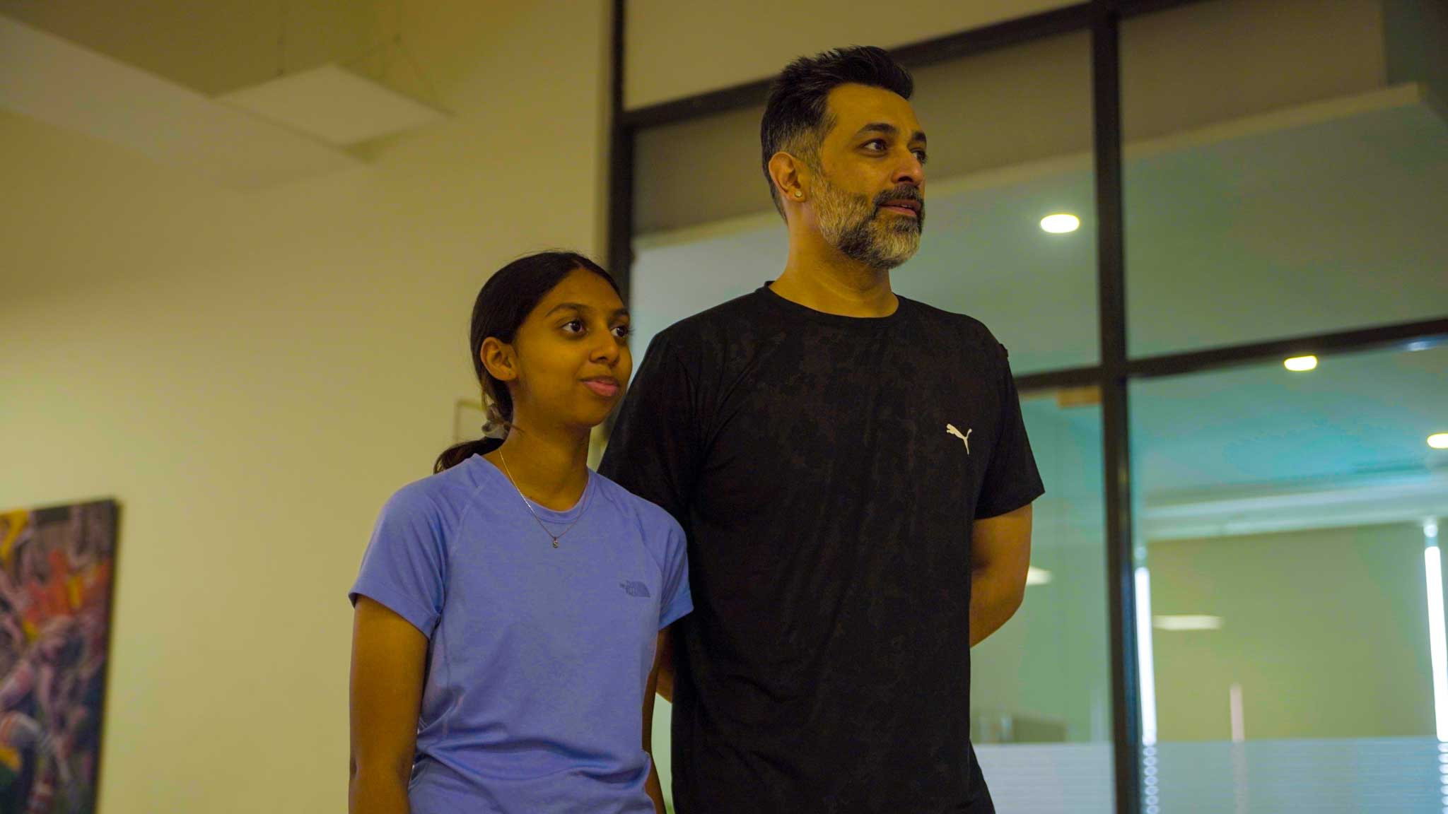 Man and young girl standing side by side indoors during Bengaluru’s Best Playcation.